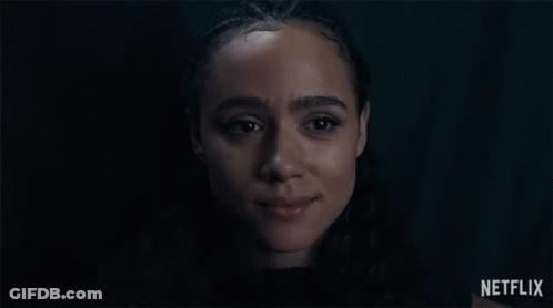 A Close Up Of A Woman 'S Face With A Netflix Logo In The Background GIF