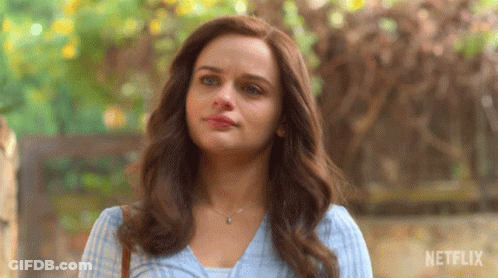 A Close Up Of A Woman 'S Face With A Netflix Logo In The Background GIF