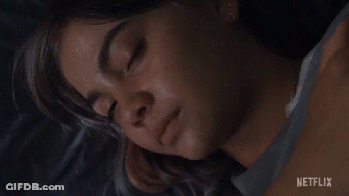 A Close Up Of A Woman 'S Face With A Netflix Logo In The Corner GIF