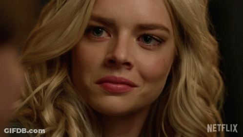 A Close Up Of A Woman 'S Face With A Netflix Logo On The Bottom GIF