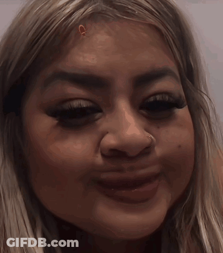 A Close Up Of A Woman 'S Face With A Nose Piercing GIF