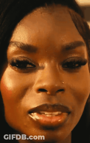 A Close Up Of A Woman 'S Face With A Nose Piercing GIF