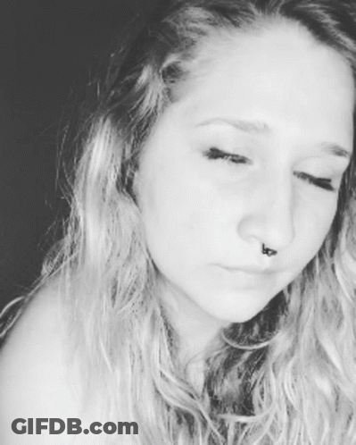 A Close Up Of A Woman 'S Face With A Nose Ring GIF
