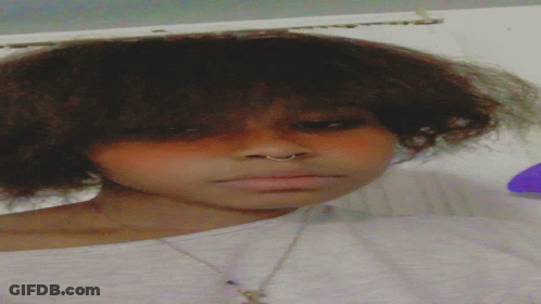 A Close Up Of A Woman 'S Face With A Nose Ring And A Necklace GIF