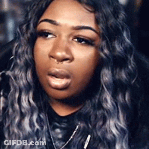 A Close Up Of A Woman 'S Face With A Nose Ring And Gray Hair . GIF