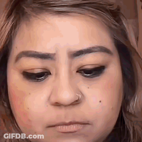 A Close Up Of A Woman 'S Face With A Nose Ring On Her Nose . GIF