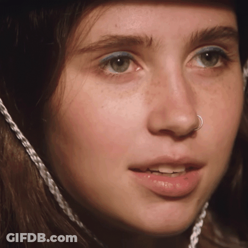 A Close Up Of A Woman 'S Face With A Nose Ring On It GIF