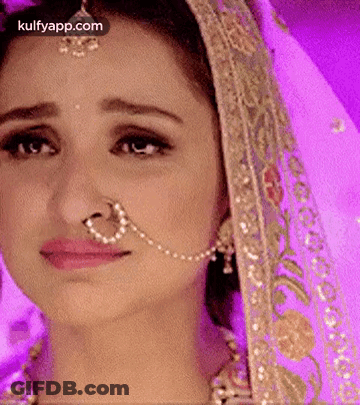 A Close Up Of A Woman 'S Face With A Nose Ring . GIF