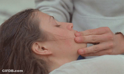 A Close Up Of A Woman 'S Face With A Person 'S Hand On It GIF