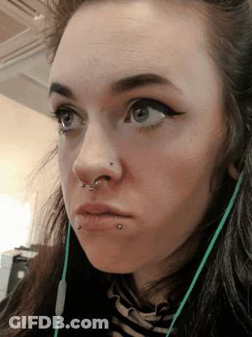 A Close Up Of A Woman 'S Face With A Piercing In Her Nose GIF