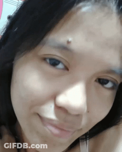 A Close Up Of A Woman 'S Face With A Piercing On Her Forehead GIF