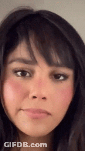 A Close Up Of A Woman 'S Face With A Pink Cheek GIF