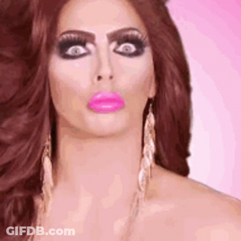 A Close Up Of A Woman 'S Face With A Pink Lip And Earrings . GIF