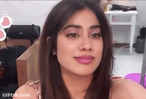 A Close Up Of A Woman 'S Face With A Pink Lip Gloss On Her Lips . GIF