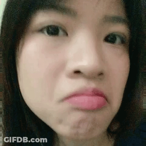 A Close Up Of A Woman 'S Face With A Pink Lip . GIF