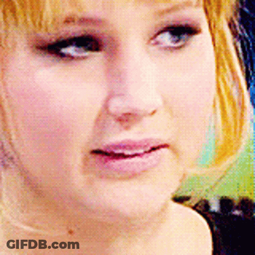 A Close Up Of A Woman 'S Face With A Pink Lip GIF