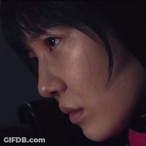 A Close Up Of A Woman 'S Face With A Pink Shirt On GIF