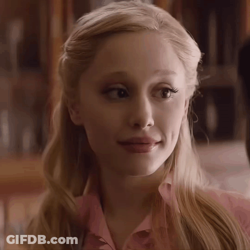 A Close Up Of A Woman 'S Face With A Pink Shirt On GIF