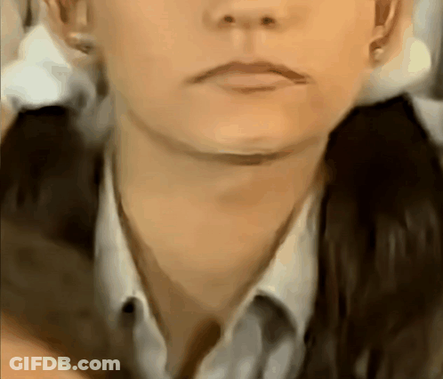 A Close Up Of A Woman 'S Face With A Ponytail GIF
