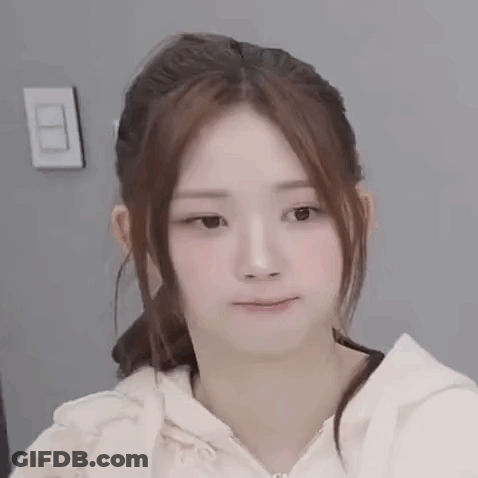 A Close Up Of A Woman 'S Face With A Ponytail And A Hoodie . GIF