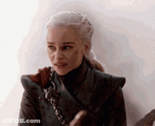 A Close Up Of A Woman 'S Face With A Ponytail And A Sword In Her Hand . GIF