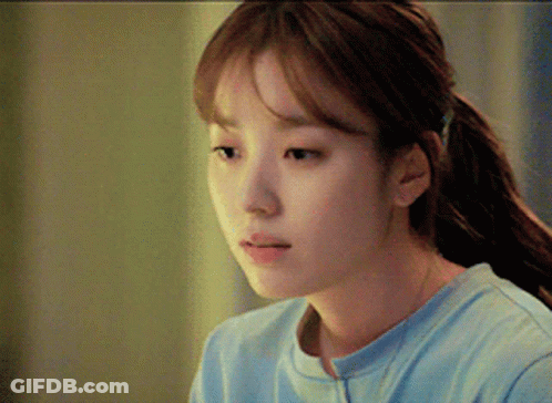 A Close Up Of A Woman 'S Face With A Ponytail GIF