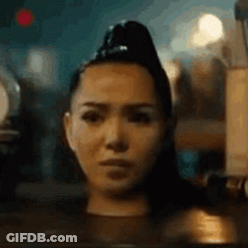 A Close Up Of A Woman 'S Face With A Ponytail . GIF