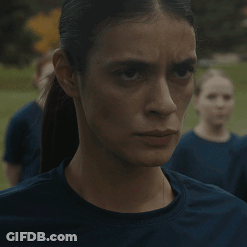 A Close Up Of A Woman 'S Face With A Ponytail GIF