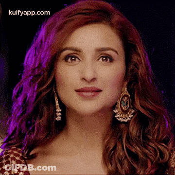 A Close Up Of A Woman 'S Face With A Purple Background . GIF
