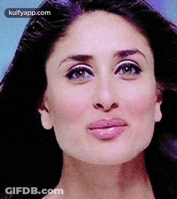 A Close Up Of A Woman 'S Face With A Purple Background And A Pink Lip . GIF