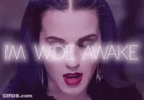 A Close Up Of A Woman 'S Face With A Purple Background And The Words `` I 'M Wide Awake '' Behind Her GIF