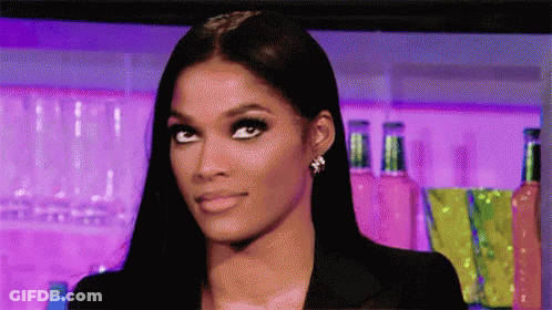 A Close Up Of A Woman 'S Face With A Purple Background . GIF
