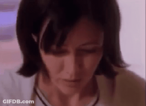 A Close Up Of A Woman 'S Face With A Purple Background . GIF