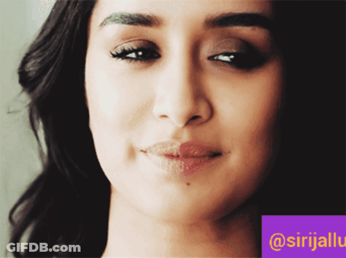 A Close Up Of A Woman 'S Face With A Purple Border That Says @Srijalu GIF