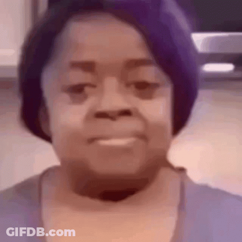A Close Up Of A Woman 'S Face With A Purple Hat . GIF