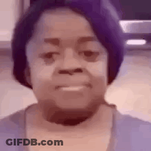 A Close Up Of A Woman 'S Face With A Purple Hat . GIF