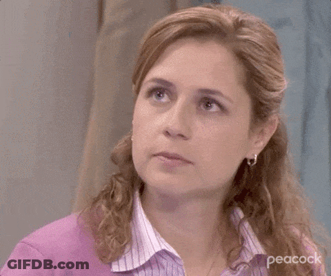 A Close Up Of A Woman 'S Face With A Purple Shirt On . GIF