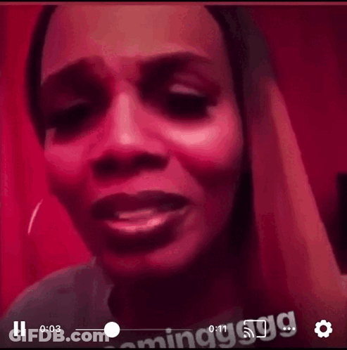 A Close Up Of A Woman 'S Face With A Red Background GIF