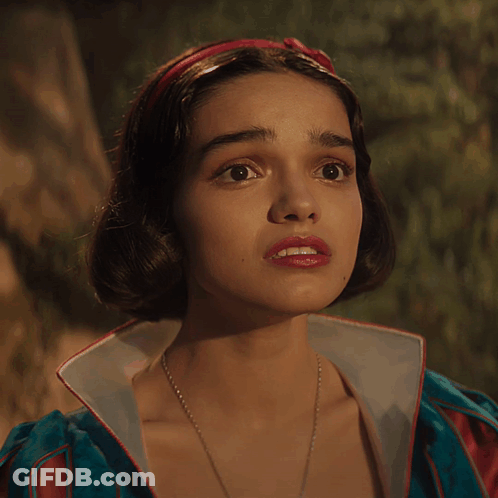 A Close Up Of A Woman 'S Face With A Red Headband On Her Head GIF