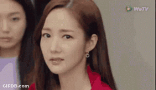 A Close Up Of A Woman 'S Face With A Red Jacket On . GIF