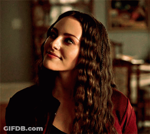 A Close Up Of A Woman 'S Face With A Red Jacket On GIF