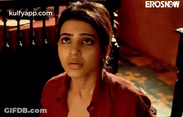 A Close Up Of A Woman 'S Face With A Red Shirt On . GIF