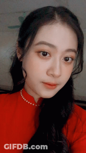 A Close Up Of A Woman 'S Face With A Red Shirt On GIF