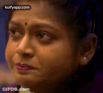 A Close Up Of A Woman 'S Face With A Red Spot On Her Nose . GIF