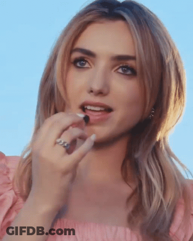 A Close Up Of A Woman 'S Face With A Ring On Her Left Hand GIF