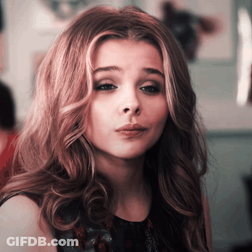 A Close Up Of A Woman 'S Face With A Sad Look On Her Face GIF