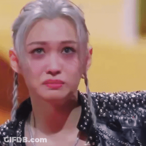 A Close Up Of A Woman 'S Face With A Sad Look On Her Face . GIF