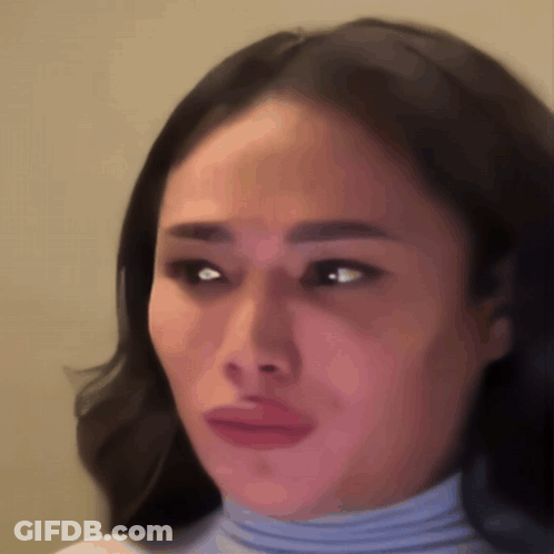 A Close Up Of A Woman 'S Face With A Sad Look On Her Face GIF