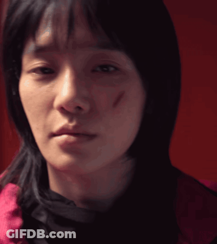 A Close Up Of A Woman 'S Face With A Scar On Her Face GIF