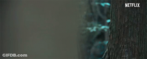 A Close Up Of A Woman 'S Face With A Scarf Around Her Neck And A Netflix Logo In The Corner . GIF